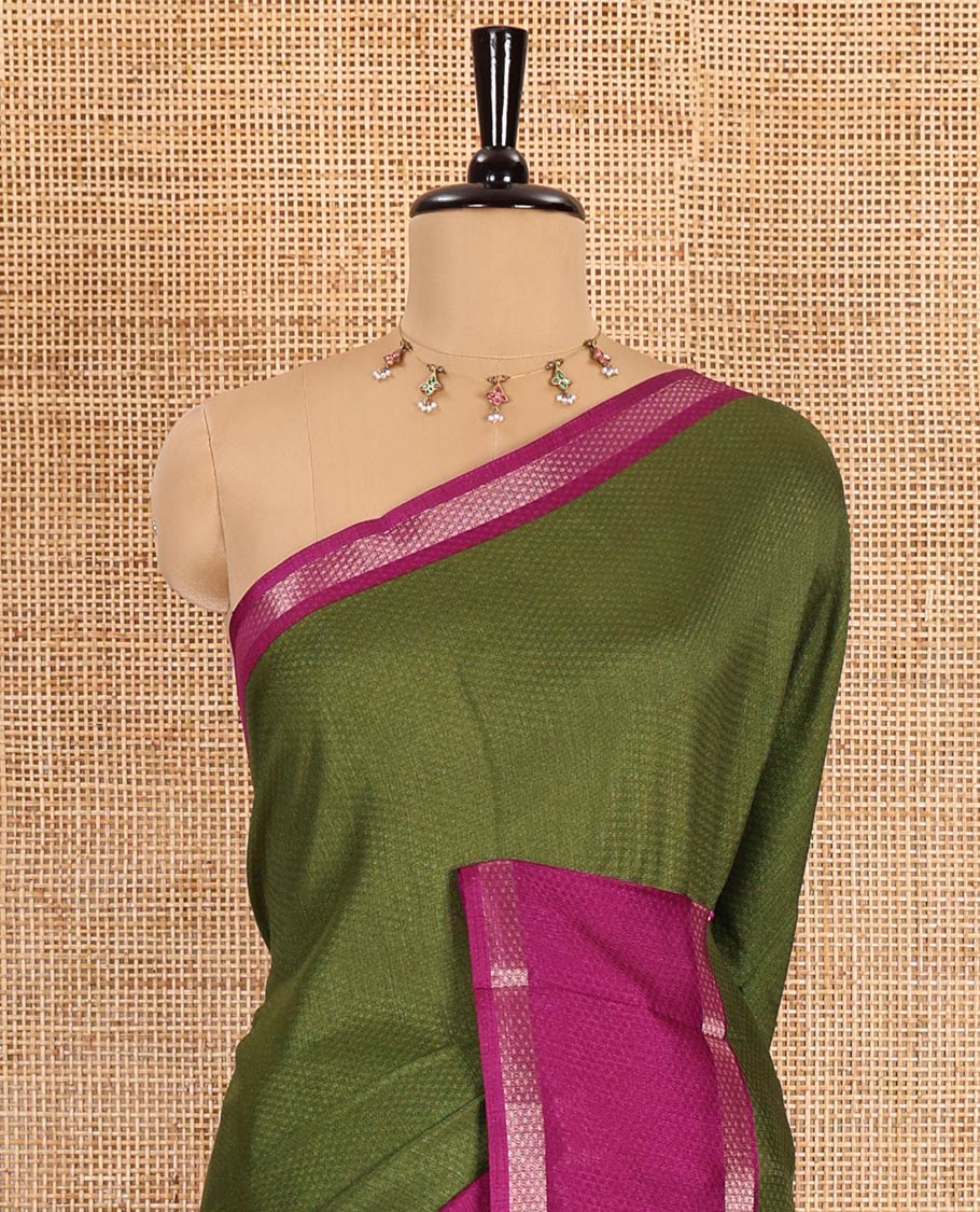Olive green embossed moss chiffon saree, contrast traditional rettai pettu border, embossed pallu, and a contrast embossed blouse