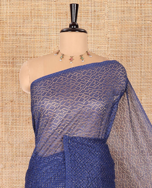 Borderless navy blue sparkling glitter russel net saree with self-pallu, and a contrast floral printed and zig-zag patterned blouse