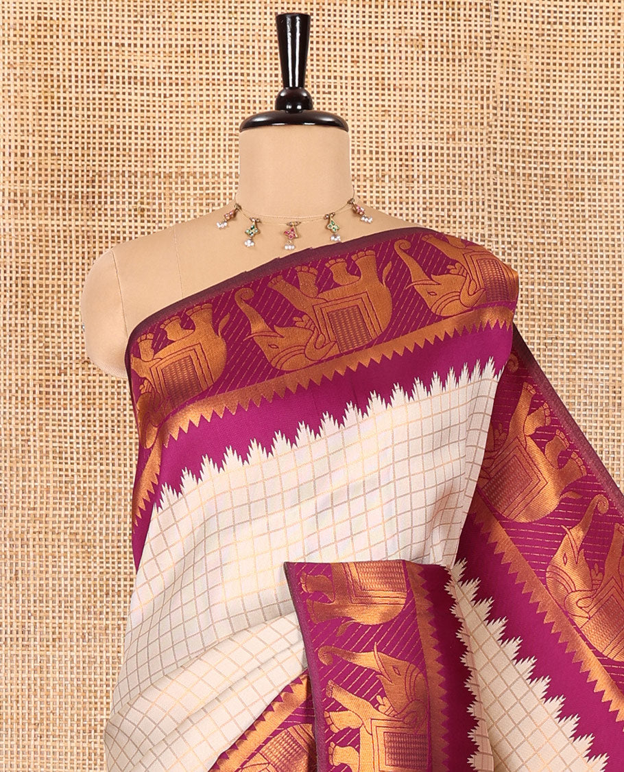 Beige checked design litchi saree, contrast temple elephant motifs border, geometric patterned pallu, and a contrast jacquard blouse