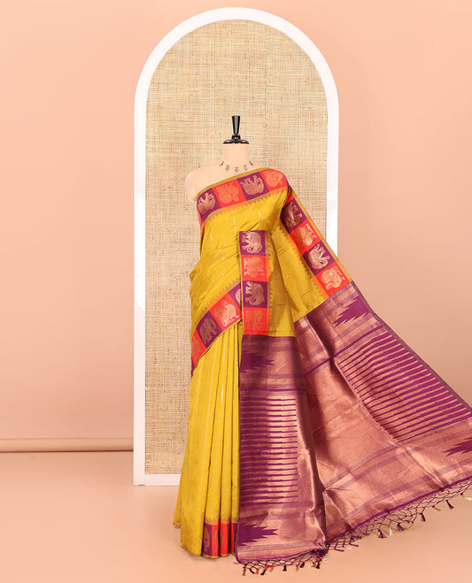 Yellow copper zari buttas woven kanchi silk saree, contrast temple border of peacock and elephant motifs, zari-rich pallu, and a zari design blouse