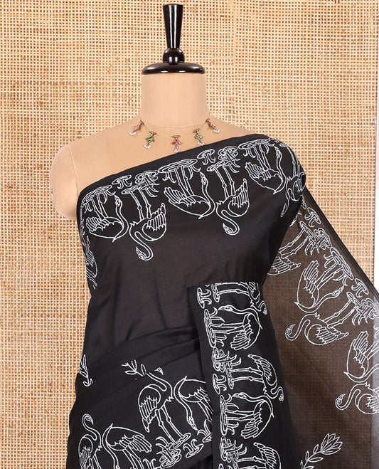 Black South Cotton Saree, Highlighted with Floral Motifs Printed All Over Its Body, Flamigo Motifs Printed Border, and Paired with One Matching Flamigo Printed Blouse, One Contrast Floral Motifs Block Printed Blouse