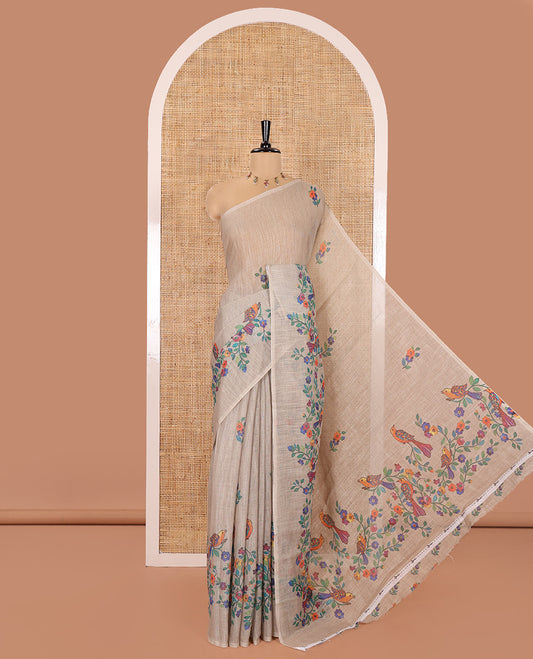 Borderless Chikku Linen Cotton Saree, Artfully Designed with Kaleidoscope-Colored Floral and Bird Motifs Print, Pallu Mirrors the Same Print, and Paired with a Matching Floral Printed Blouse