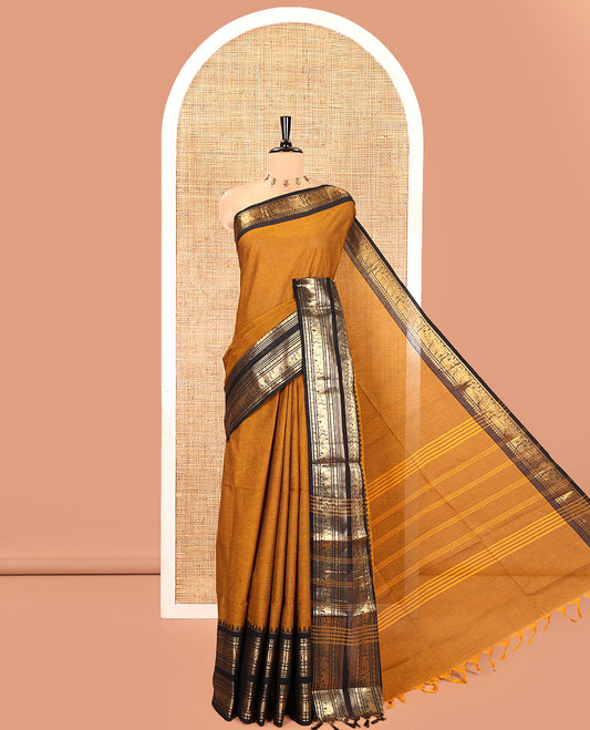 Mustard Plain Chettinad Cotton Saree, Complemented by a Contrast Rettai Pettu Temple Sliver-Sheen-Gold Zari Border of Coin, Elephant, and Peacock Designs, Subtly Striped Pallu, and Paired with a Matching Blouse