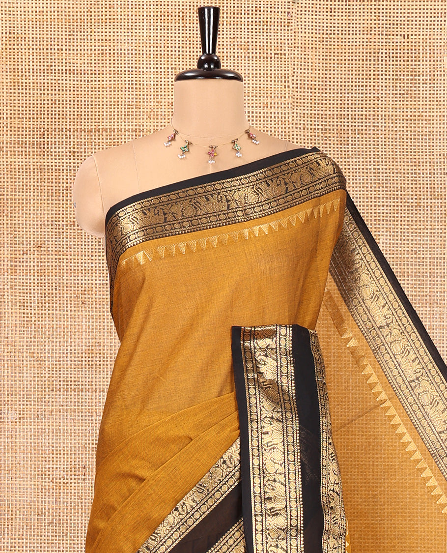 Mustard Plain Chettinad Cotton Saree, Complemented by a Contrast Rettai Pettu Lite-Gold-Zari Border of Temple, Coin, Elephant, and Peacock Designs, Subtly Striped Pallu, and Paired with a Matching Blouse