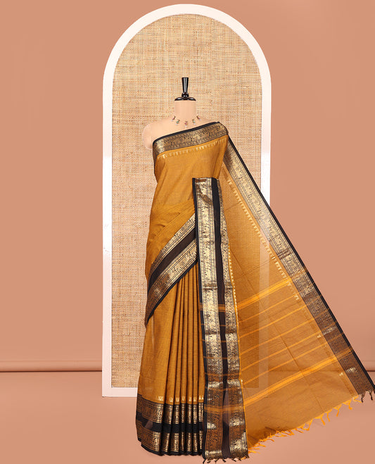 Mustard Plain Chettinad Cotton Saree, Complemented by a Contrast Rettai Pettu Lite-Gold-Zari Border of Temple, Coin, Elephant, and Peacock Designs, Subtly Striped Pallu, and Paired with a Matching Blouse