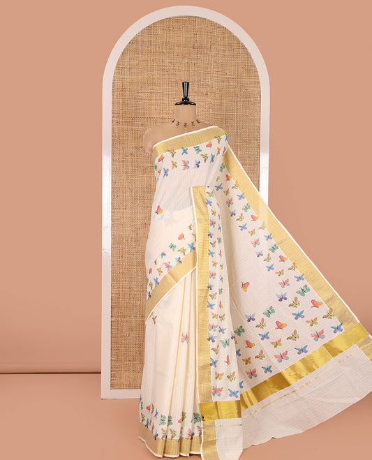 Off-White Kerala Cotton Saree, Adorned with Zari Stripes and Colorful Butterflies, Highlighted by a Zari Border, Pallu of Butterfly Motifs, and Paired with a Matching Blouse
