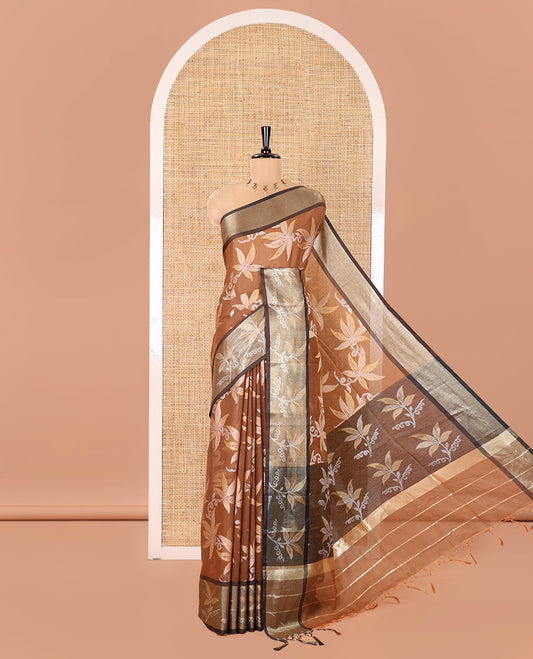 Brown Chanderi Cotton Saree, Prettified with Leaf Motifs on Its Body, Complemented by a Contrast Border of Leaf Designs, Pallu Steeped with Colorful Floral Designs, and Paired with a Contrast Blouse