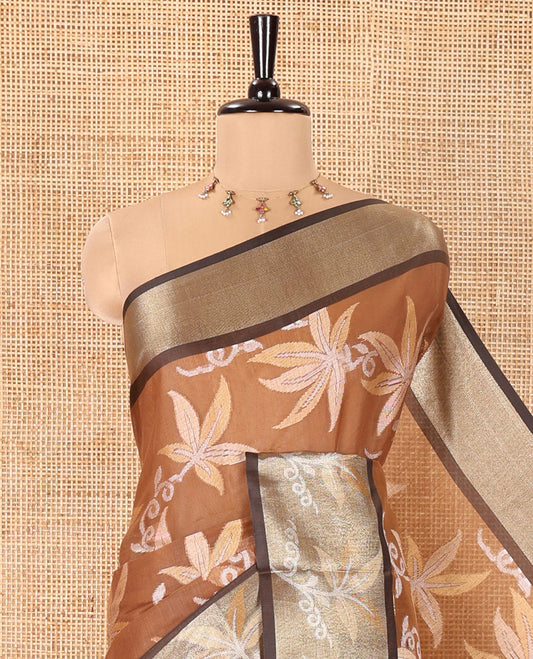 Brown Chanderi Cotton Saree, Prettified with Leaf Motifs on Its Body, Complemented by a Contrast Border of Leaf Designs, Pallu Steeped with Colorful Floral Designs, and Paired with a Contrast Blouse