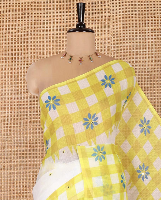 White and Green Linen Cotton Saree, Adorned with Mirror Work On Its Body, Complemented by Contrast Temple Checked Border of Floral Print and Mirror Work, Pallu Mirrors the Same Design and Paired with a Contrast Blouse