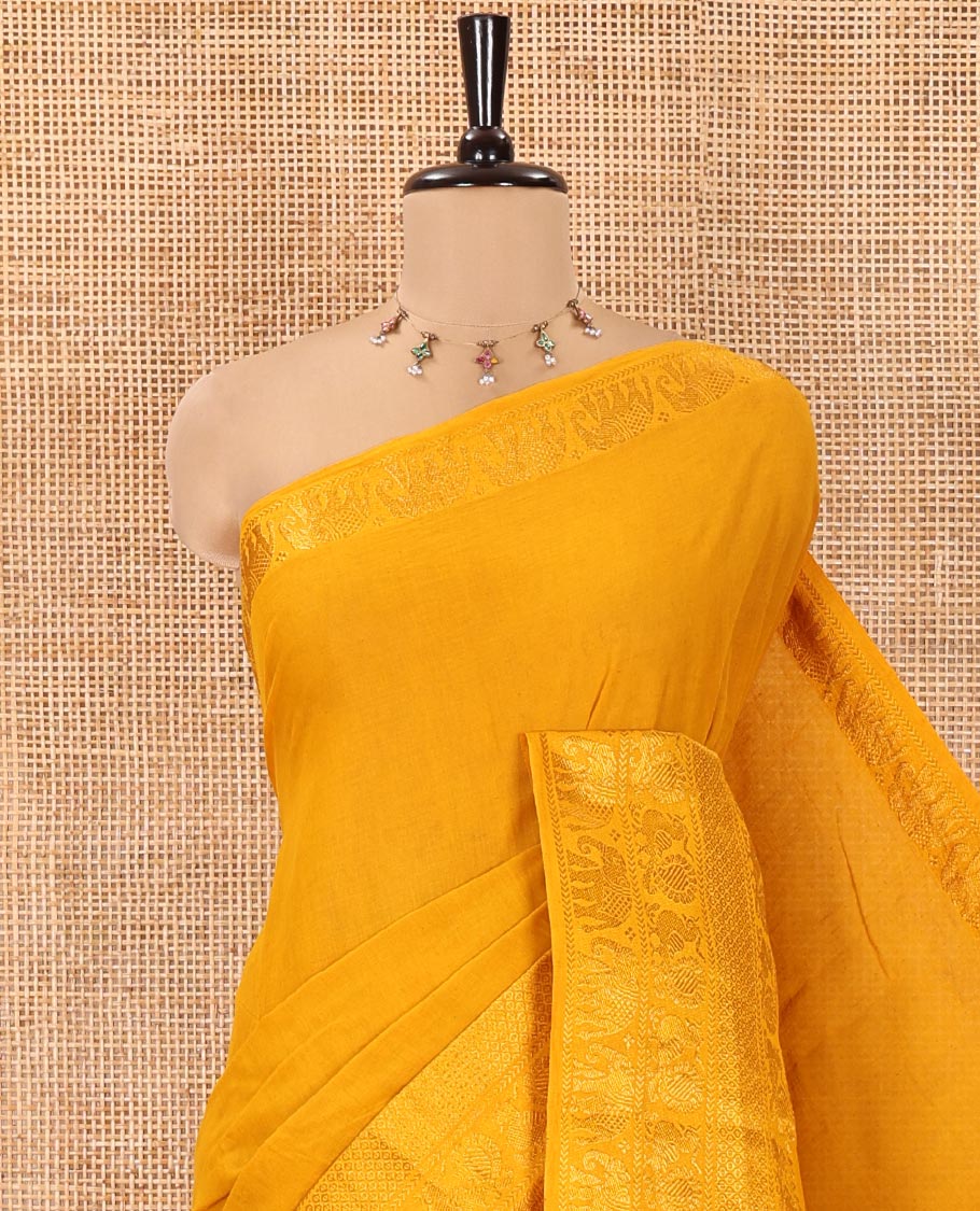 Mustard Plain Sungudi Cotton Saree, Highlighted by Traditional Zari Border of Peacock and Elephant Motifs Weave, Subtly Striped Pallu, and Paired with a Contrast Veldhari Design Blouse