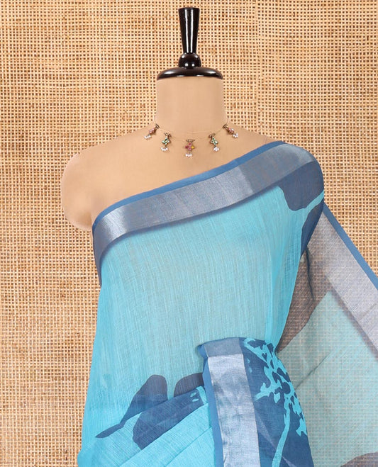 Blue Linen Cotton Saree, Prettified with Floral Print All Over Its Body, Complemented by a Contrast Zari Bavanji Border, Floral Printed Pallu, and Paired with a Matching Blouse