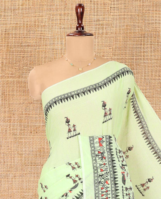 Pista Green Khadi Mul Cotton Saree, Artfully Printed with Warli Motifs All Over Its Body, Highlighted by a Self-Border of Warli Print, Pallu of Warli Print, and Paired with a Matching Blouse