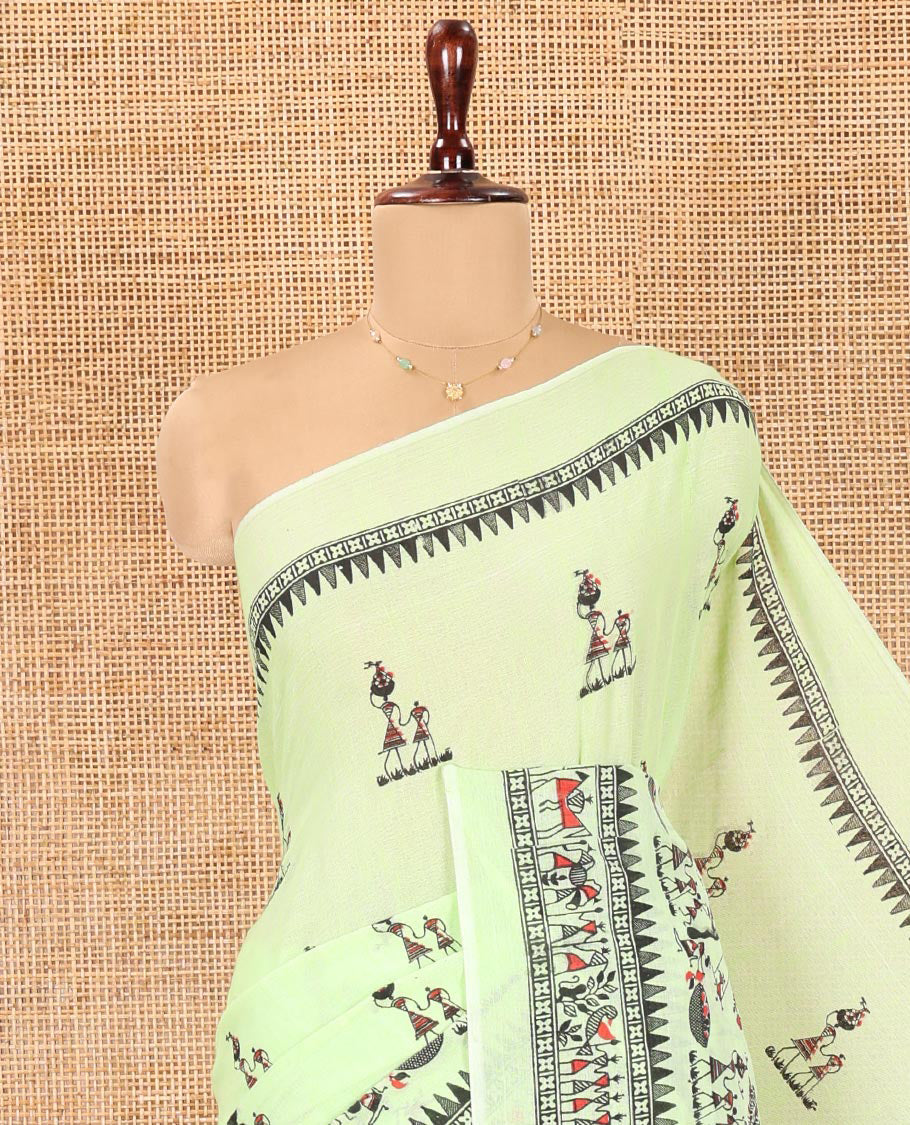 Pista Green Khadi Mul Cotton Saree, Artfully Printed with Warli Motifs All Over Its Body, Highlighted by a Self-Border of Warli Print, Pallu of Warli Print, and Paired with a Matching Blouse