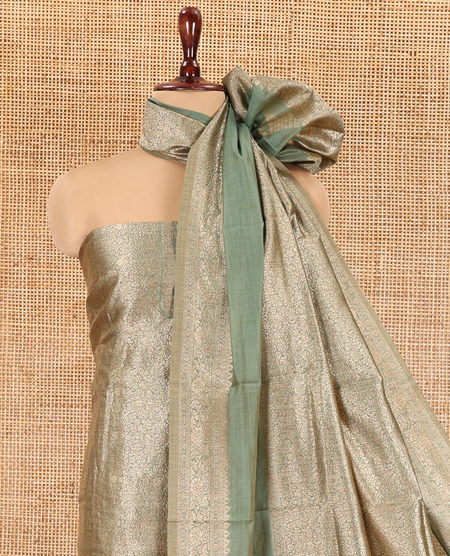 Green Banarasi Material Chudidar Features Jacquard Top, a Matching Santoon Bottom, and an Intricately Designed Dupatta
