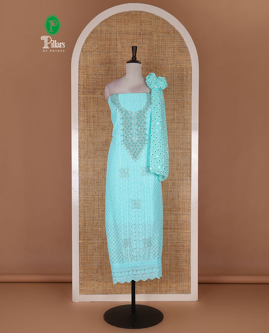 Aqua green material churidar set, stone work with Schiffli style embroidered georgette top, American Crape bottom, and polka dotted printed mirror work dupatta