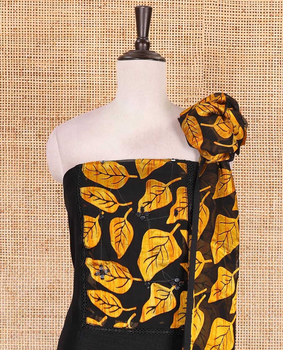 Black and yellow material churidar set, neck leaf print with mirror work Vichitra silk top, plain santoon bottom, and leaf printed shimmer georgette dupatta