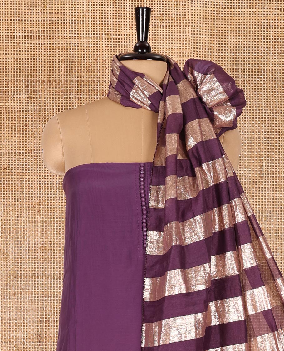 Lavender material chudidar set, plain with pom-pom tasseled mul chanderi top, a matching bottom, and organza dupatta of stripes