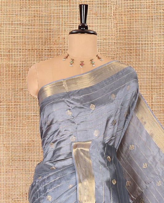 Grey zari buttas and striped banana pith saree, bavanji border, zari striped pallu, and a matching blouse