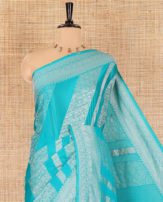 Rama green geometric and intricate designs zari woven fancy crepe saree, traditional zari border, floral-star gridded pallu, and a matching blouse