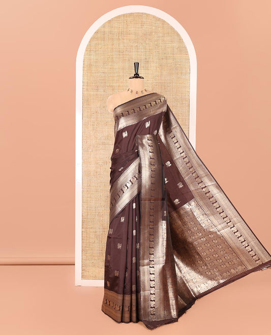 Coffee Brown Litchi Silk Saree, Richly Detailed with Peacock Buttas All Over Its Body, Highlighted by a Traditional Zari Border of Peacock Designs, Grand Pallu of Butta Enclosed Zari Checks, and Paired with a Matching Blouse