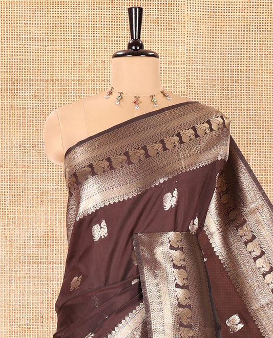 Coffee Brown Litchi Silk Saree, Richly Detailed with Peacock Buttas All Over Its Body, Highlighted by a Traditional Zari Border of Peacock Designs, Grand Pallu of Butta Enclosed Zari Checks, and Paired with a Matching Blouse