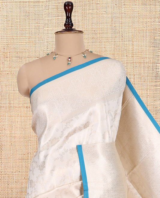 Off-White-Peacock Blue Semi-Silk Saree, Adorned with Floral Jacquard Design, a Zari Paisley Border, and a Contrast Blouse