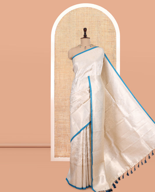 Off-White-Peacock Blue Semi-Silk Saree, Adorned with Floral Jacquard Design, a Zari Paisley Border, and a Contrast Blouse