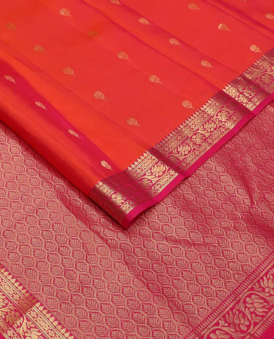 Orange floral buttas Vasundhara silk mix saree, contrast border of thilakam, muthu, cross kamalam, and kodi visiry designs, and ogee patterned pallu