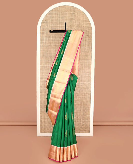 Green Vasundhara Lite Silk Mix Saree, Accentuated with Zari Buttas All Over Its Body, Complemented by a Contrast Border of Muthu, Kodi Visiry, and Mayil Kann Designs, Pallu Steeped with Stripes and Thilakam Designs, and Paired with a Contrast Blouse