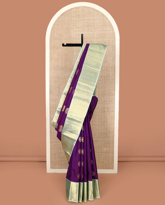 Purple Vasundhara Silk Saree Gracefully Embellished with Mayil Buttas, Complemented by a Contrast Border of Rekku, Kathir, Laddu Kamalam, and Rudraksham Designs, Subtly Sparkled Zari Woven Pallu, and Paired with a Contrast Zari-Bordered Blouse