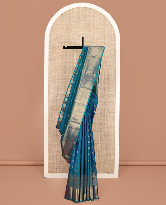 Blue Vasundhara Lite Silk Mix Saree, Ornamented With Zari Buttas All Over Its Body, Highlighted by Zari Border of Thilakam, Neli, Rudraksham, and Jaal Designs, Grand Pallu and Paired with a Matching Blouse