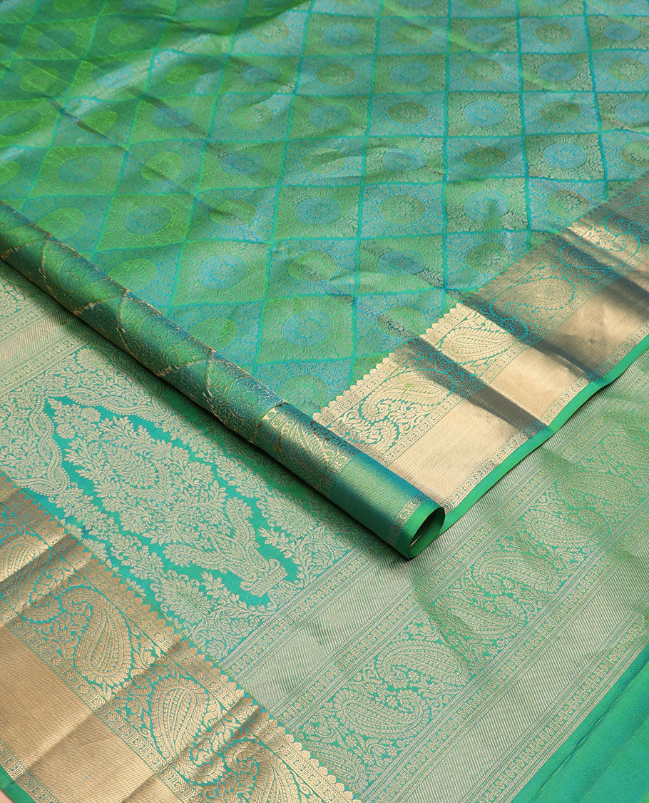 Green jacquard Kanchipuram wedding silk saree, zari border of arumbu manga designs, and intricate pallu