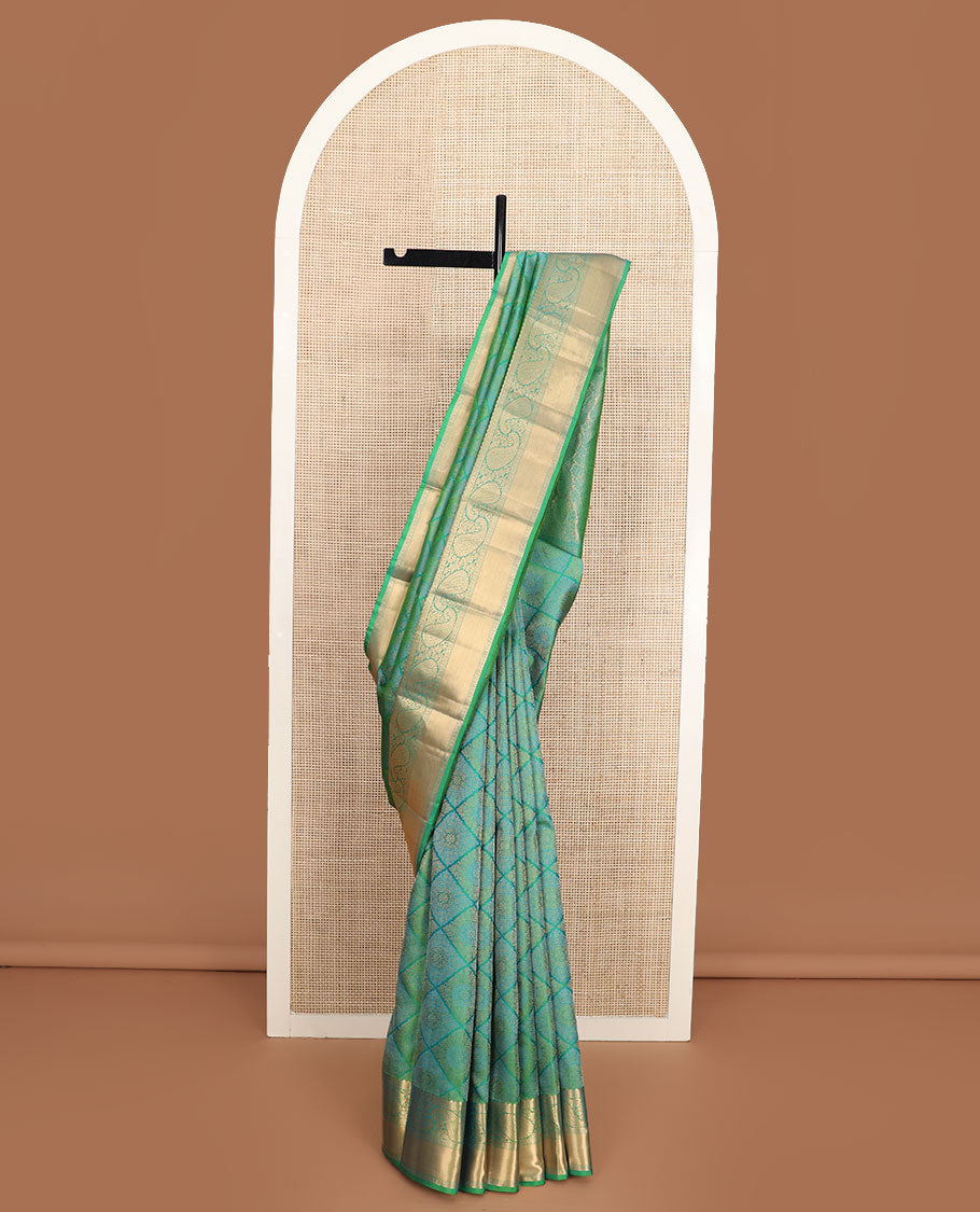 Green jacquard Kanchipuram wedding silk saree, zari border of arumbu manga designs, and intricate pallu