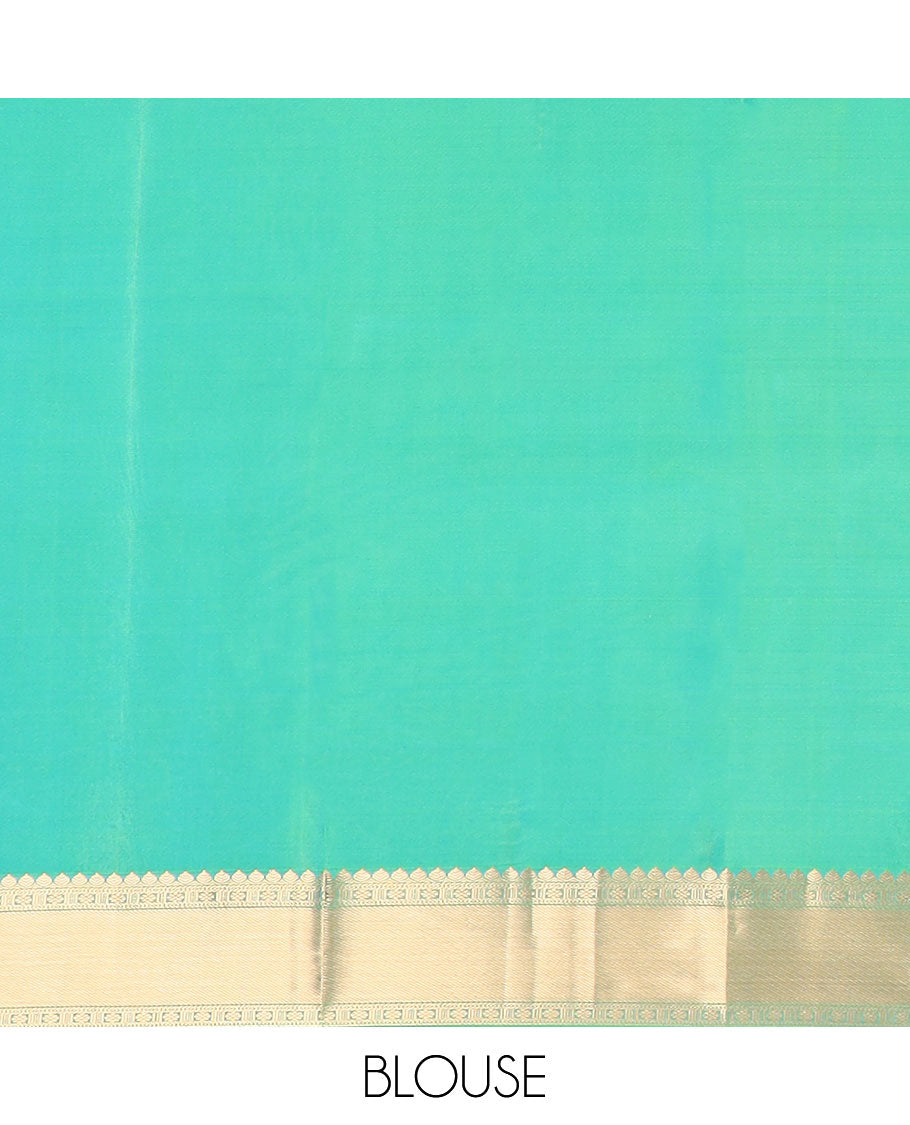 Green jacquard Kanchipuram wedding silk saree, zari border of arumbu manga designs, and intricate pallu