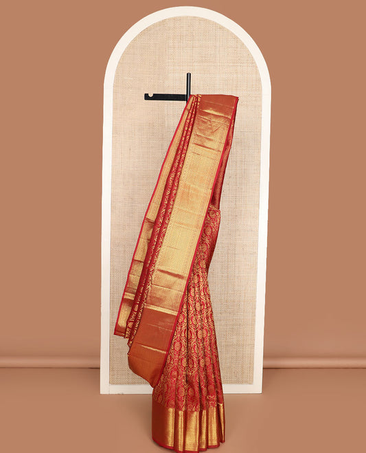 Red jacquard Kanchipuram wedding silk saree, zari border of thilakam mokku, rudraksham, and jaal designs, and ogee patterned pallu