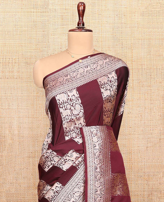 Maroon Semi-Banaras Silk Saree, Impeccably Detailed with Animal-themed Jacquard Designs on Its Body, Highlighted by a Zari Border of Traditional Designs, Pallu Steeped with Stripes, and Paired with a Matching Blouse