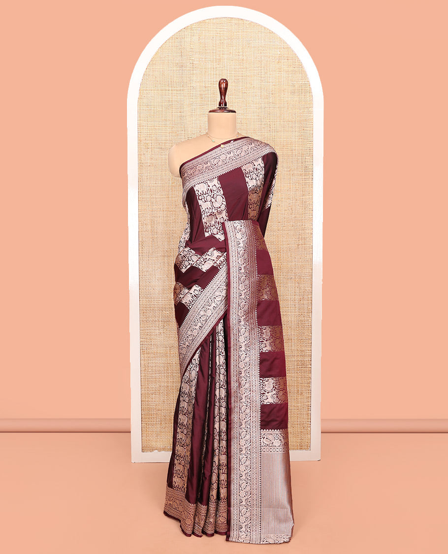 Maroon Semi-Banaras Silk Saree, Impeccably Detailed with Animal-themed Jacquard Designs on Its Body, Highlighted by a Zari Border of Traditional Designs, Pallu Steeped with Stripes, and Paired with a Matching Blouse