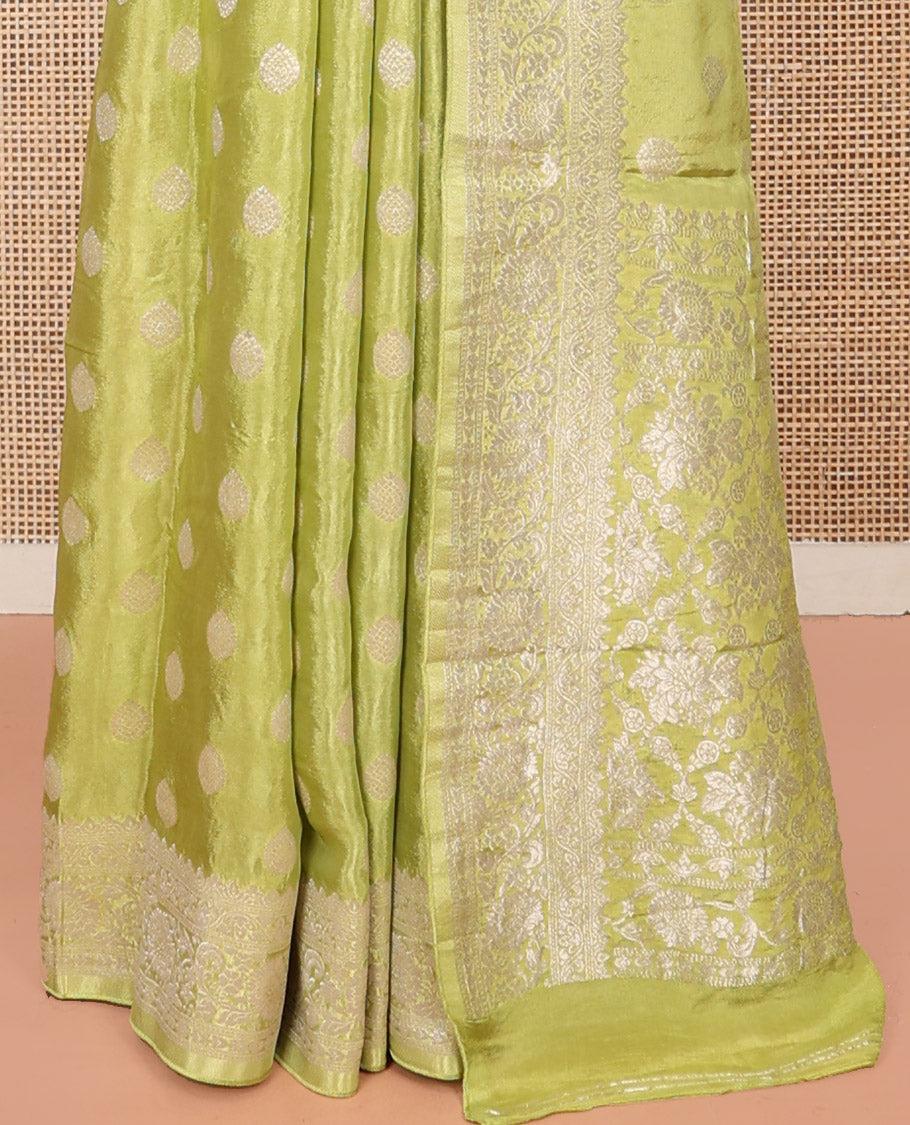 Green Fancy Crepe Saree, Gleamed Up with Thilakam Buttas, Highlighted by a Traditional Border, Intricately Designed Pallu, and a Matching Blouse