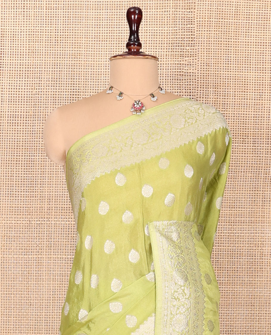 Green Fancy Crepe Saree, Gleamed Up with Thilakam Buttas, Highlighted by a Traditional Border, Intricately Designed Pallu, and a Matching Blouse