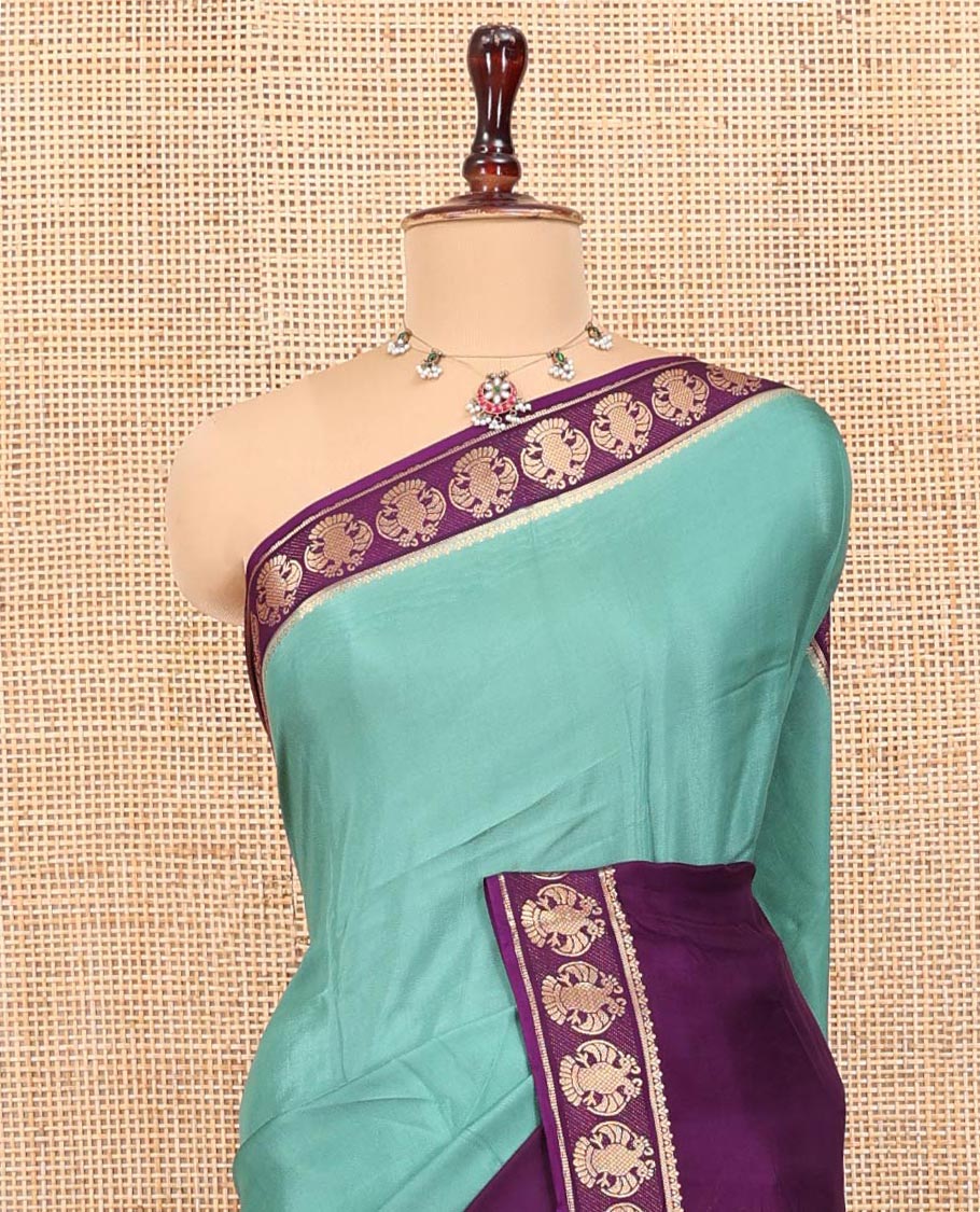 Olive Green Plain Dola Silk Saree, Complemented by Contrast Rettai Pettu Ganda Berunda Motifs, Zari Border, Gleaming Zari Striped Pallu, and Paired with a Contrast Blouse