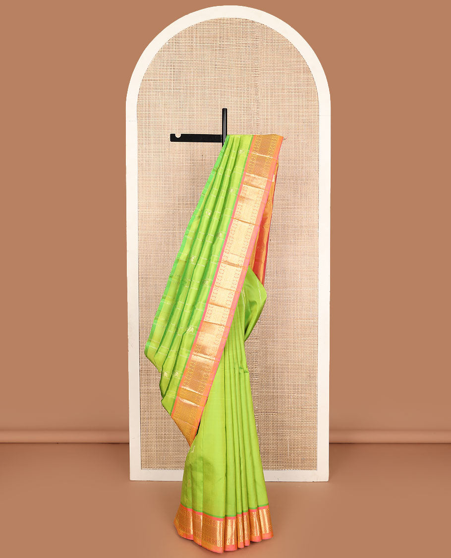 Green mayil buttas and zari stripes Kanchipuram silk saree, contrast one-sided border of laddu kamalam, and mayil kann designs, and zari design pallu