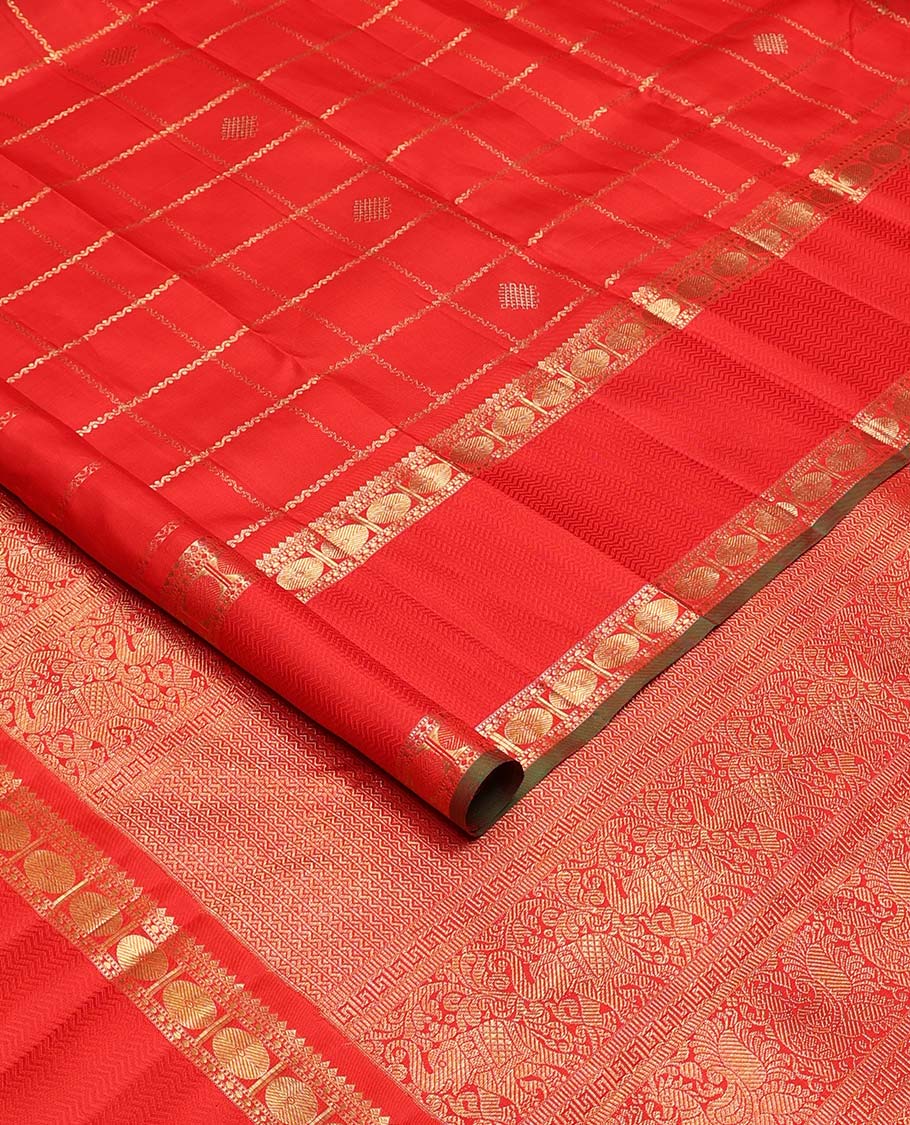 Red kolam buttas enclosed neli checked Kanchipuram silk saree, zari border of thilakam, kathir, and rudraksham designs, and pallu of neli, Greek key, yaanai, and mayil design