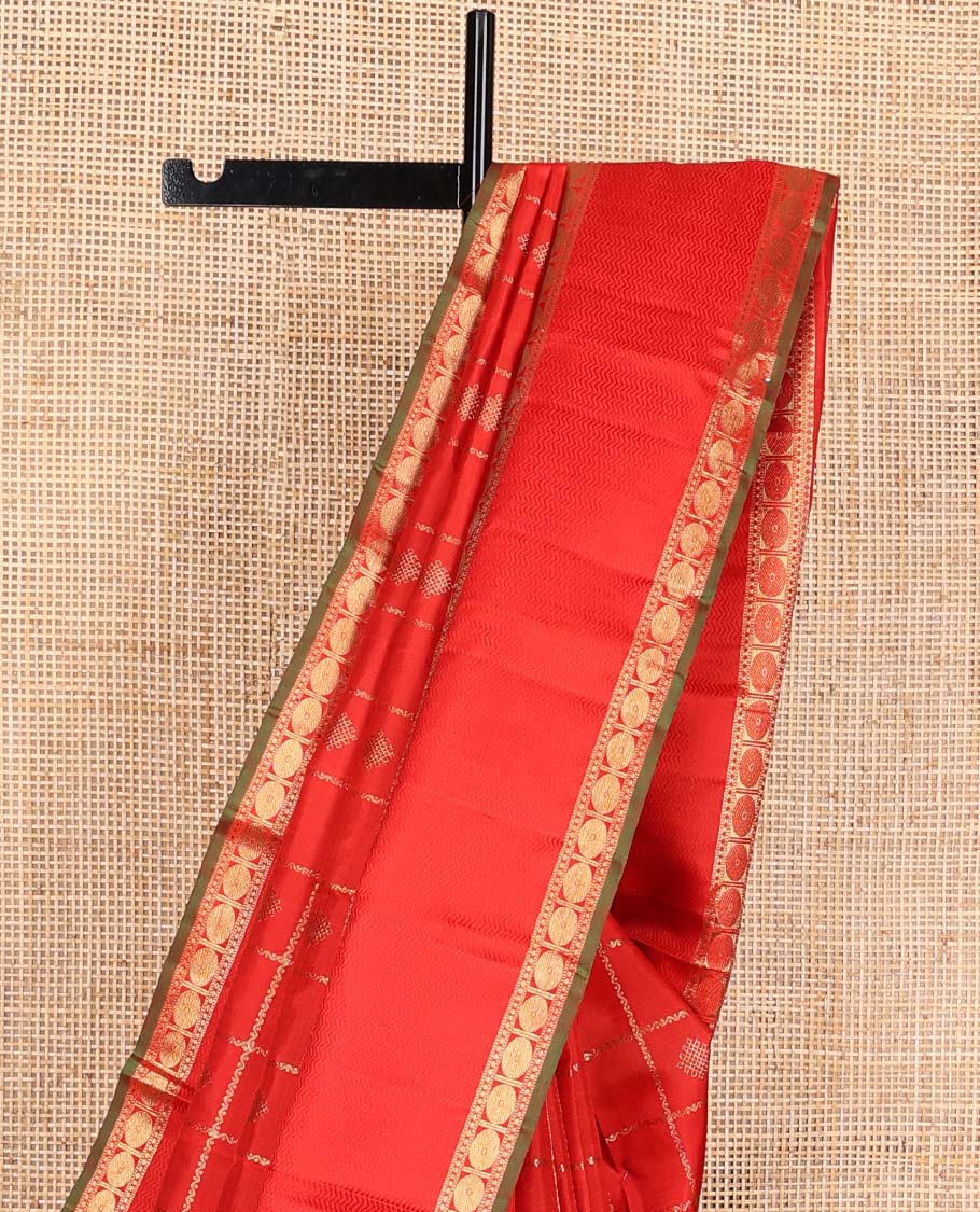 Red kolam buttas enclosed neli checked Kanchipuram silk saree, zari border of thilakam, kathir, and rudraksham designs, and pallu of neli, Greek key, yaanai, and mayil design