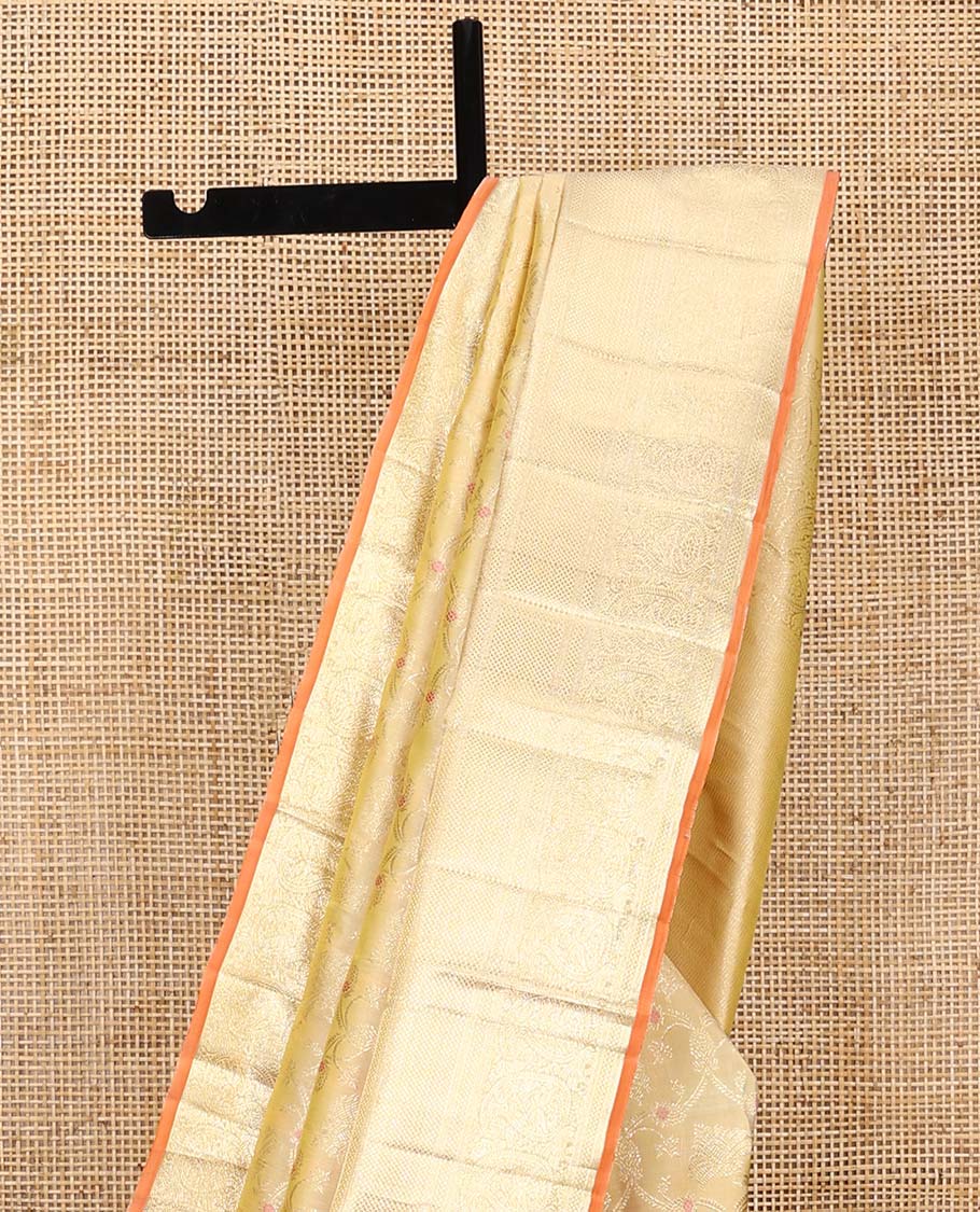 Yellow jacquard Kanchipuram silk saree, zari border of thilakam, kuyil kann, and arumbu manga designs, and geometric patterned pallu