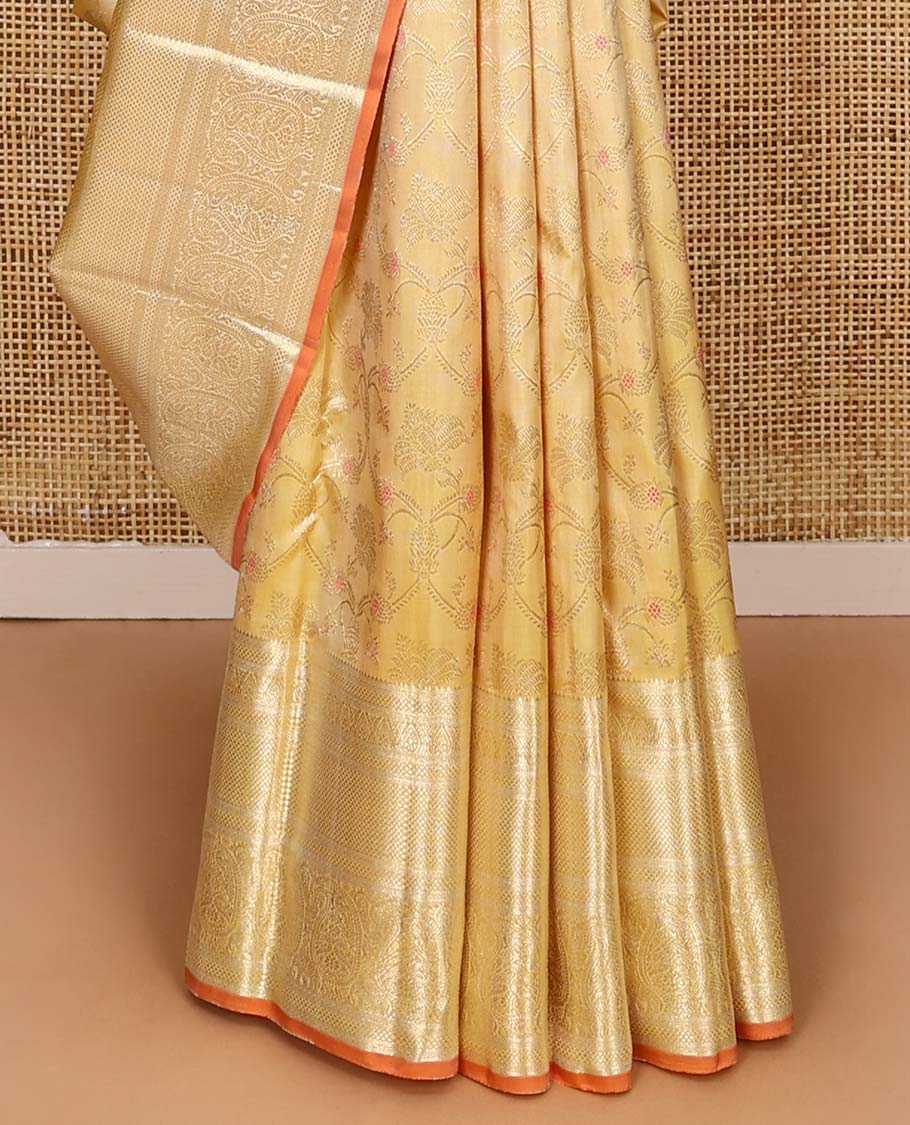 Yellow jacquard Kanchipuram silk saree, zari border of thilakam, kuyil kann, and arumbu manga designs, and geometric patterned pallu