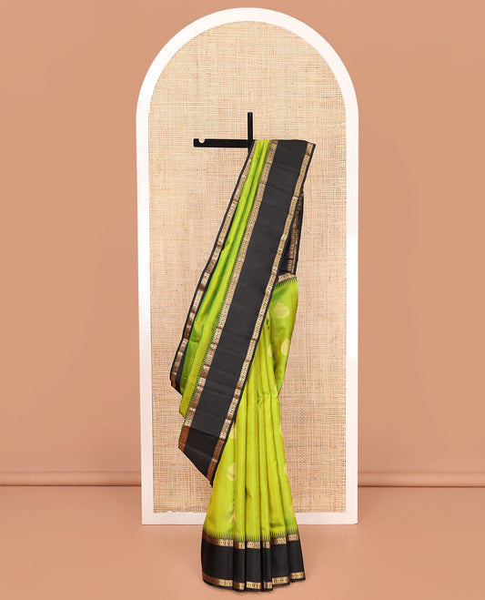 Green Vasundhara Silk Saree, Detailed with Zari Buttas on Its Body, Complemented by Contrast Temple Border of Banaras, Kathir, and Manga Designs, Grandly Woven Jaal Pallu, and Paired with a Contrast Blouse