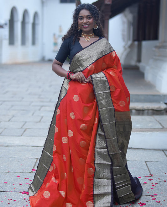 Reddish Orange Budget Silk Saree,Enriched with Floral Zari Buttas,Complemented by a Contrast Traditional Zari Design Border,Grand Pallu, and a Contrast Blouse