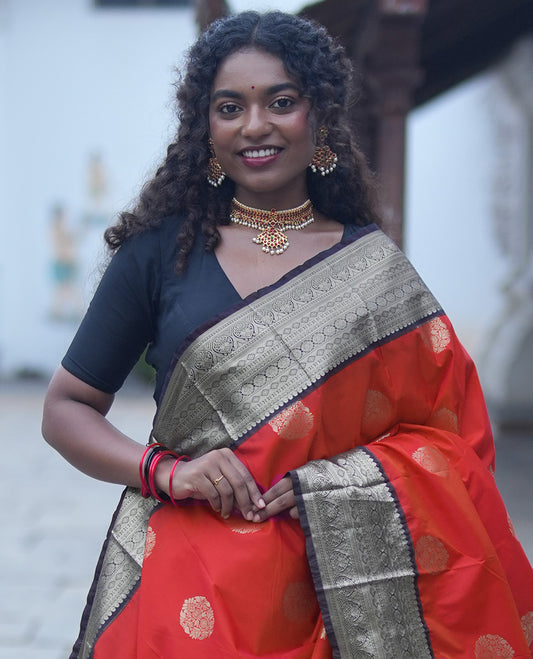Reddish Orange Budget Silk Saree,Enriched with Floral Zari Buttas,Complemented by a Contrast Traditional Zari Design Border,Grand Pallu, and a Contrast Blouse
