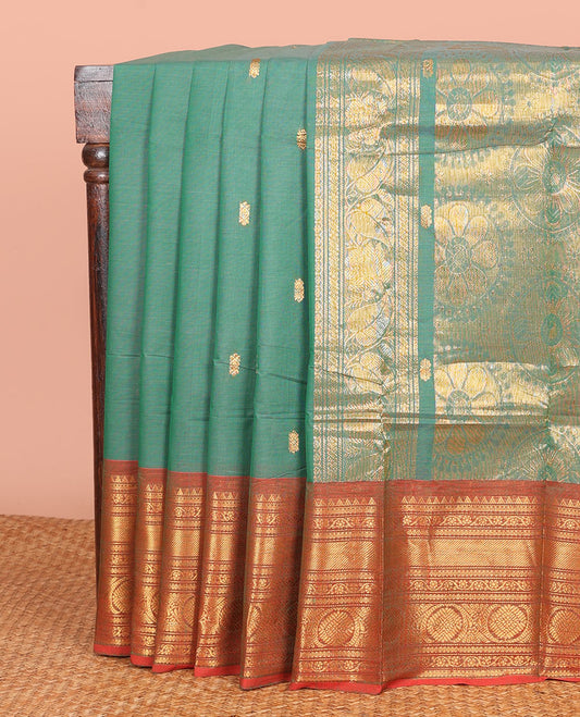 Green Chettinad Cotton Saree Embellished with Buttas All Over Its Body, Complemented by Contrast Border of Traditional Zari Designs, Pallu of Chakram Designs, and Paired with a Matching Blouse