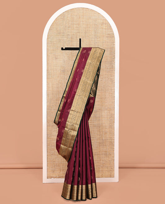 Maroon Vasundhara Lite Silk Saree, Elevated with Mayil and Yaanai Buttas All Over Its Body Complemented by Contrast Border of Mayil, Yaanai and Arumbu Manga Designs, Grand Jaal Pallu and Paired with a Contrast Blouse